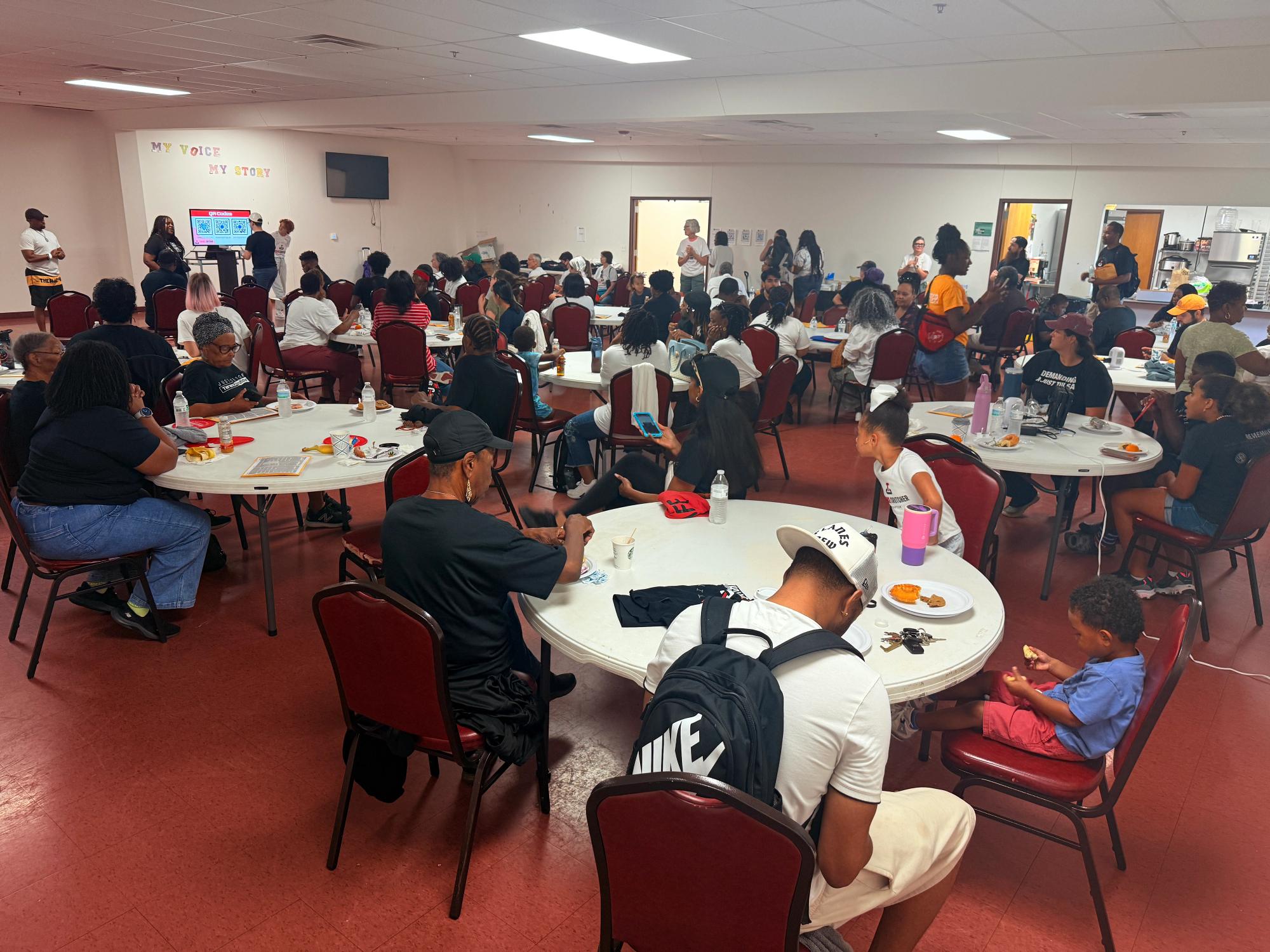 A full room of participants waiting for canvassing training