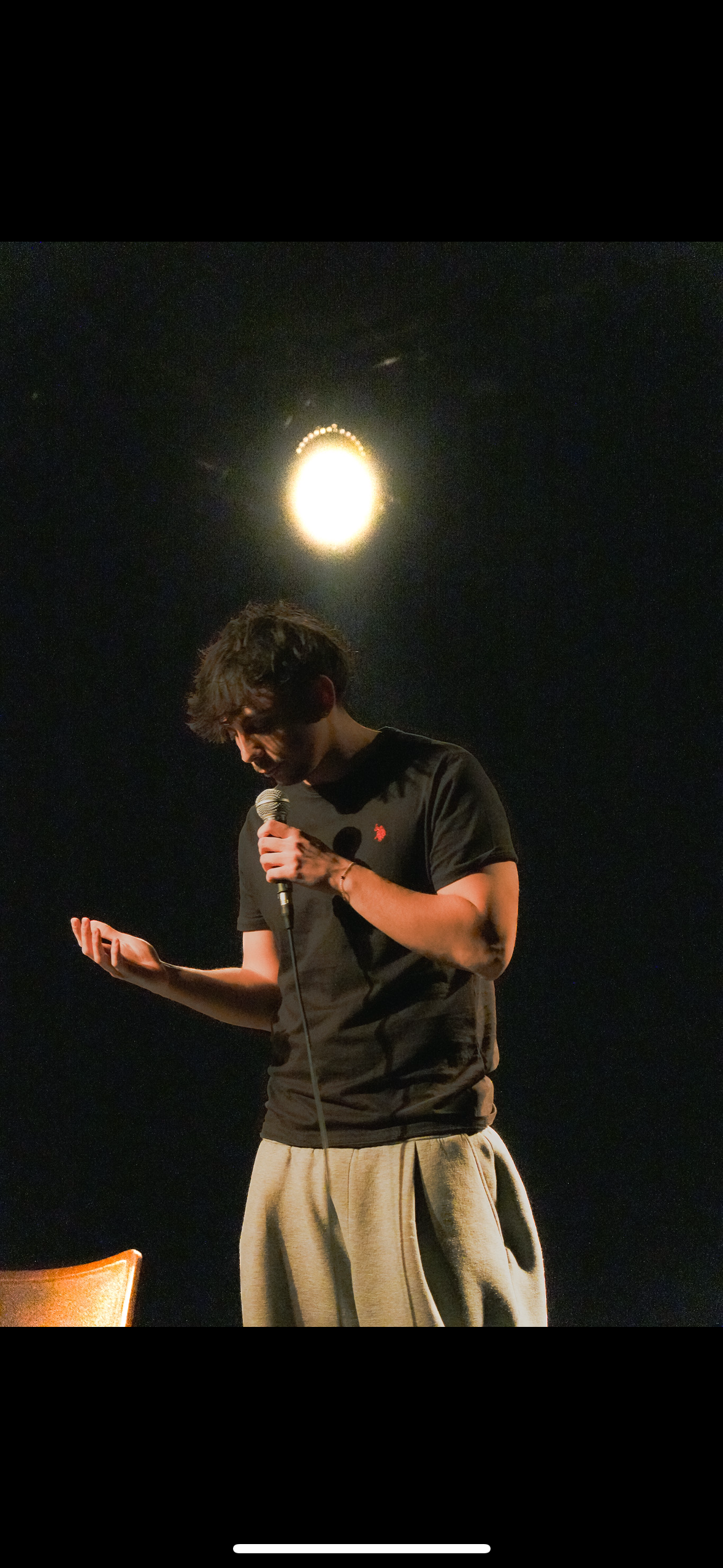 Kowsi smiling on stage.
