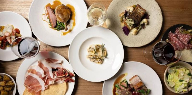 Elegant fine dining plates with wine at a private dinner