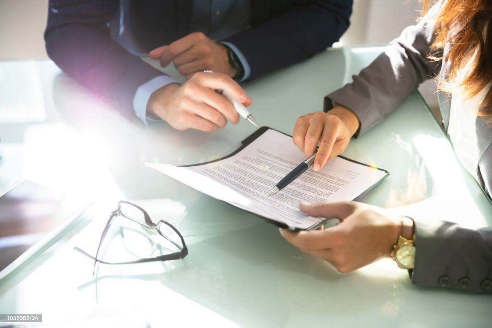 Two advisors reviewing an investment document at a desk