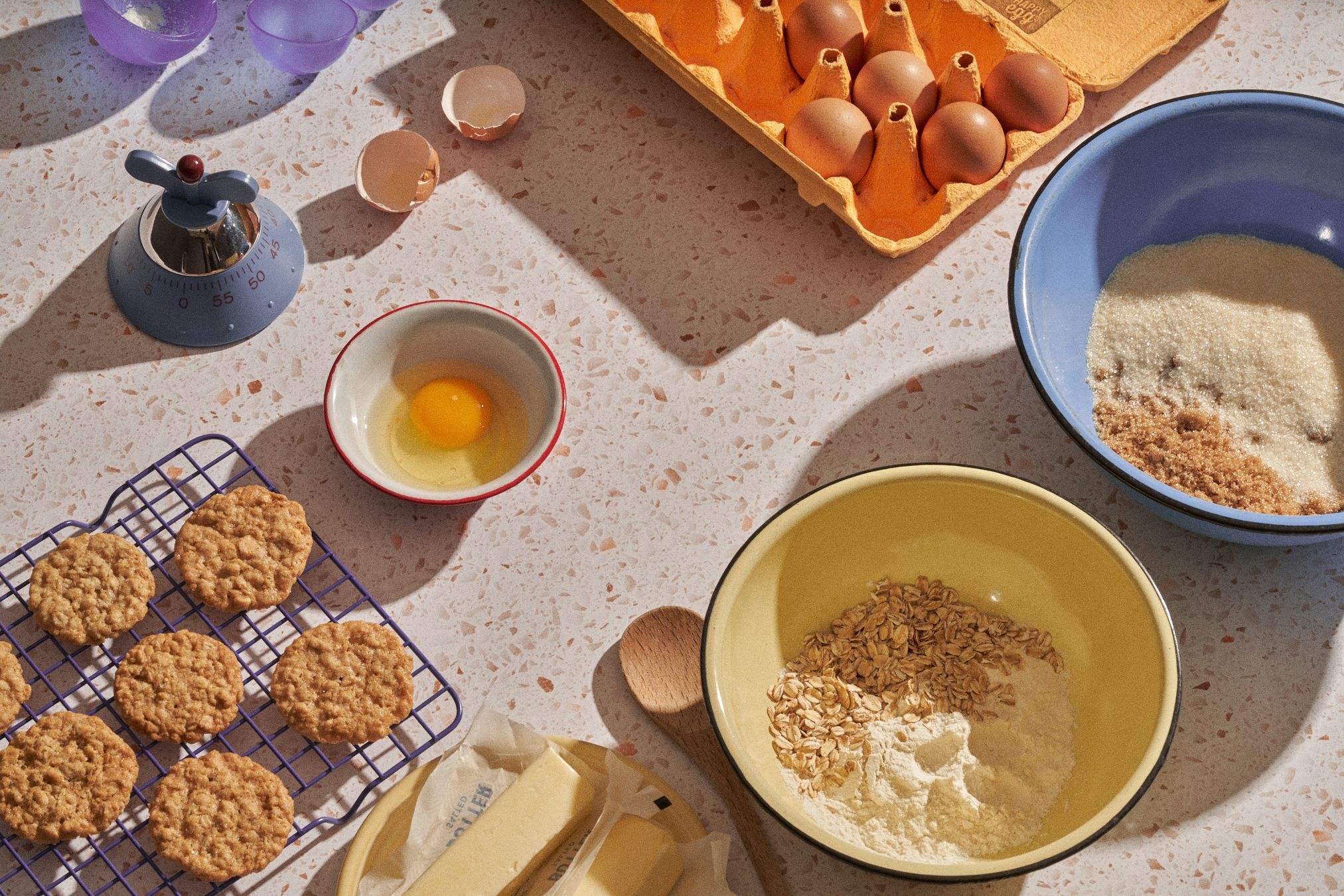 Kitchen counter with ingredients in bowls and cookies