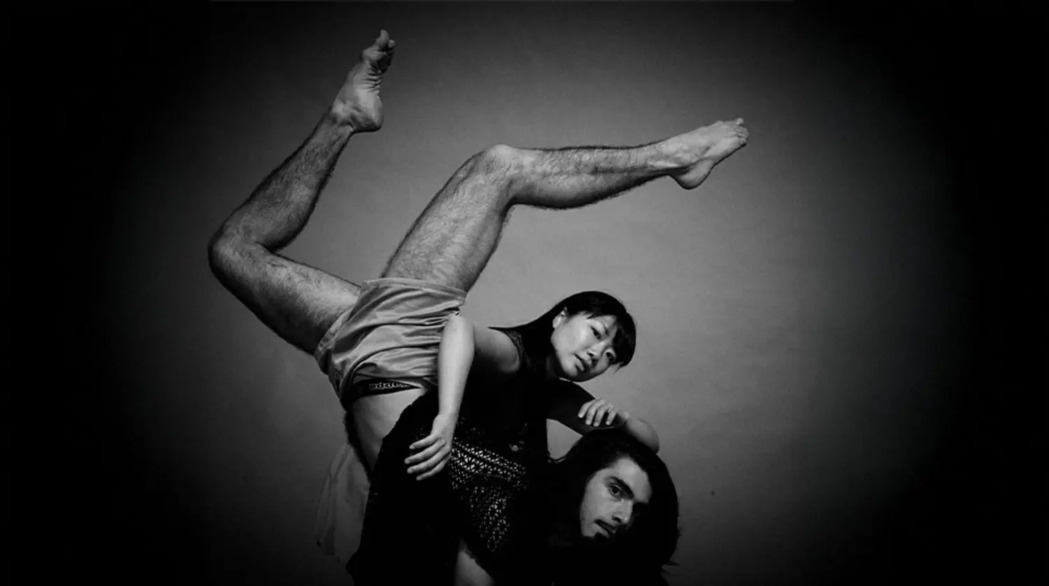 Black and white photo of two SEAD dancers doing an acrobatic pose