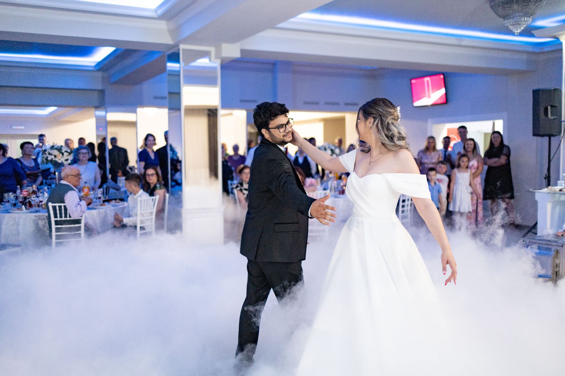 Bride and groom sharing a first dance on a low-lying Dancing On A Cloud fog effect