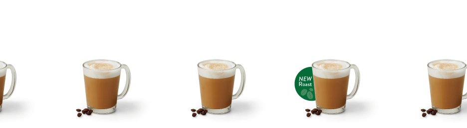 Multiple Lattes in glass mugs with froth on top