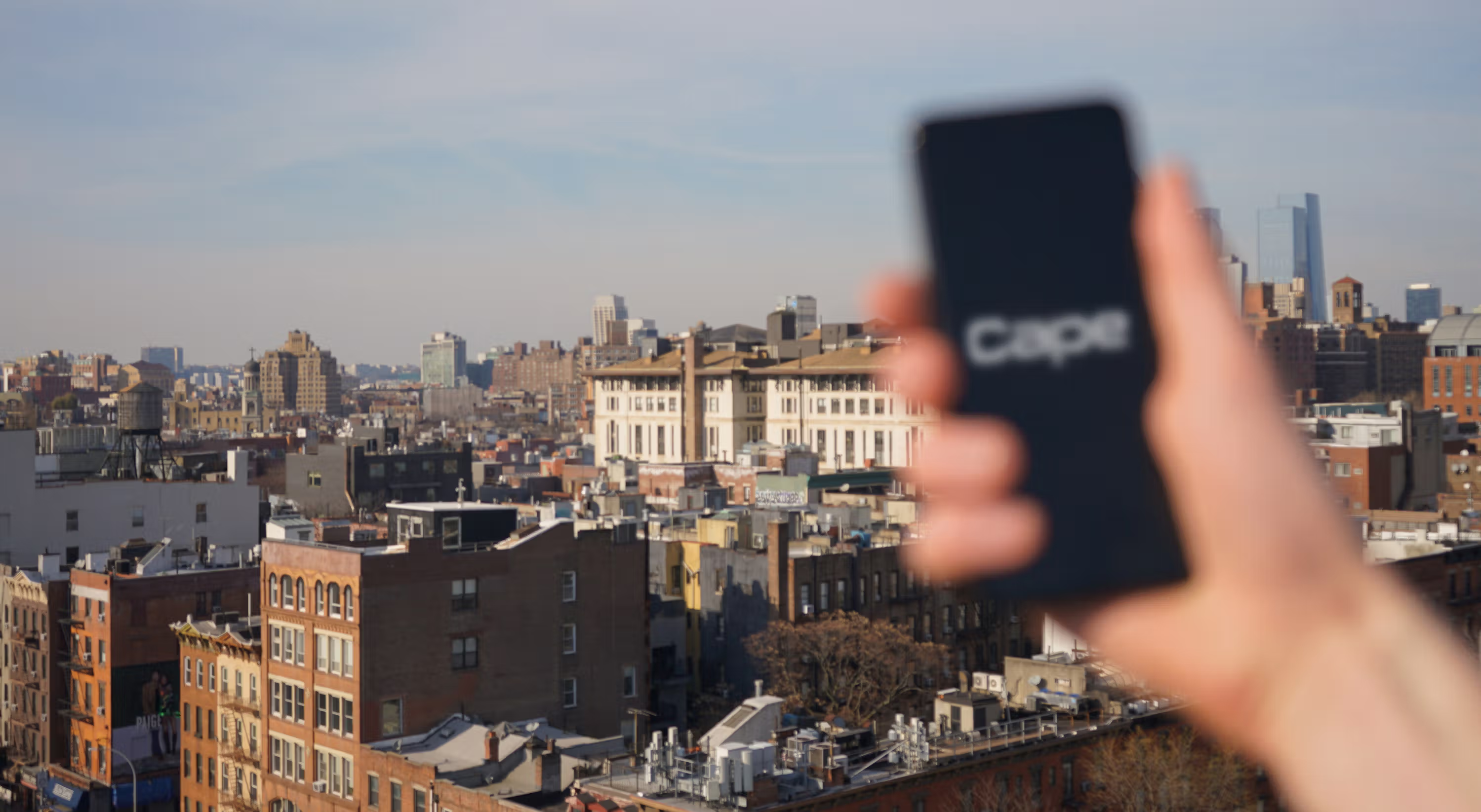 An image of a person holding a phone with cape on it