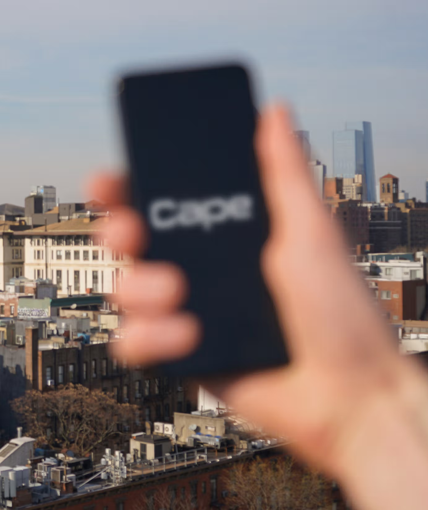 An image of a person holding a phone with cape on it