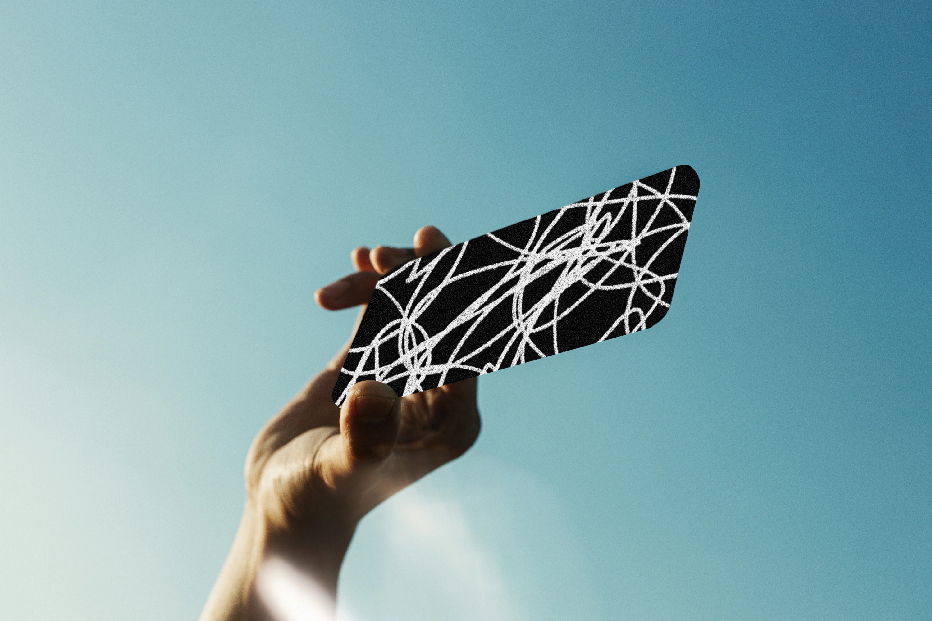 hand holding up a scribbled-out phone.
