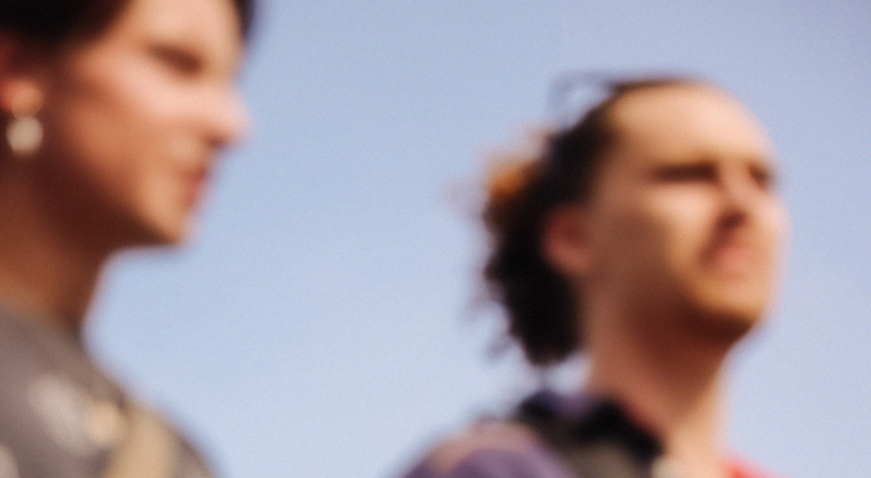 Two people standing net to each other