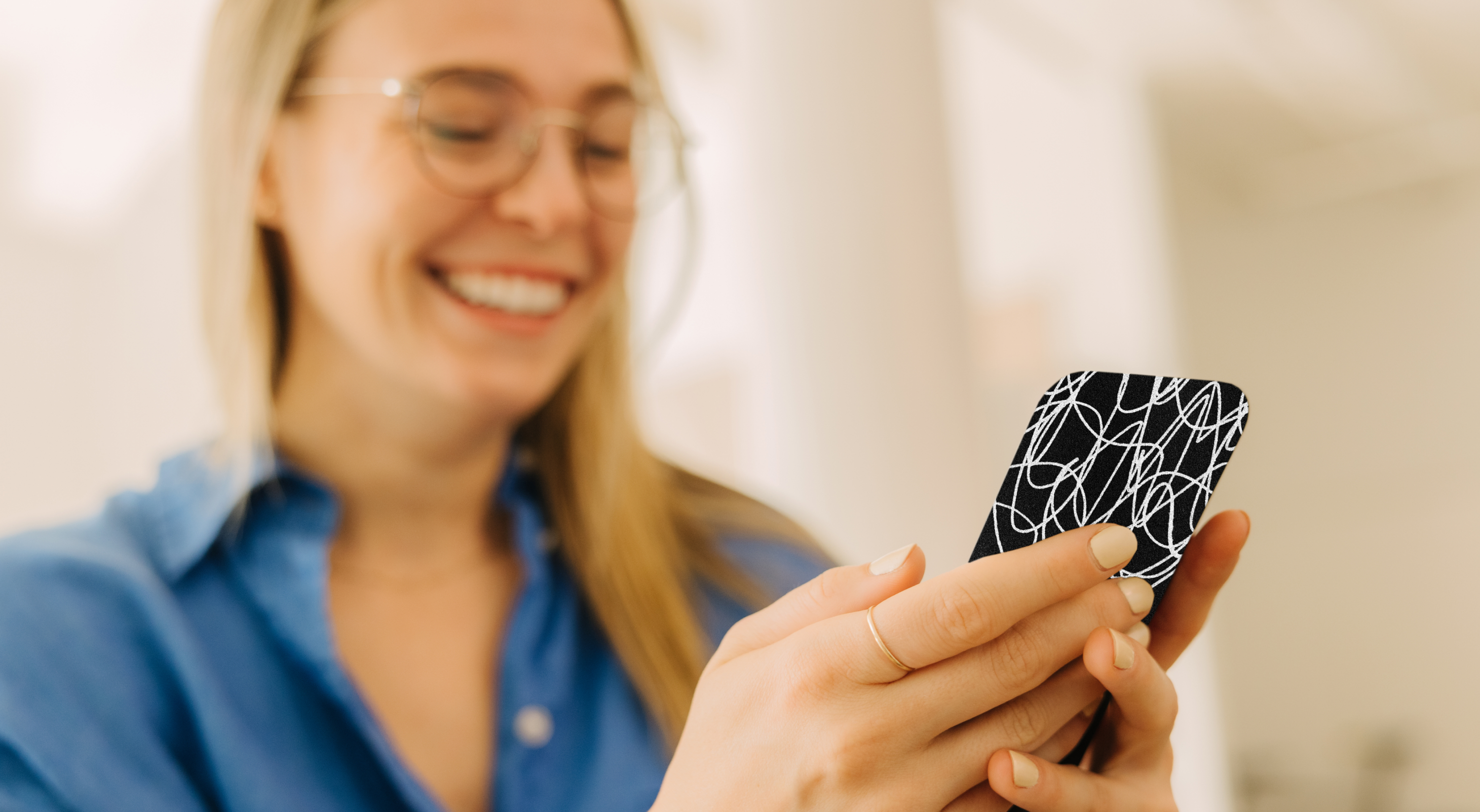 An image of a woman holding a phone protected by Cape