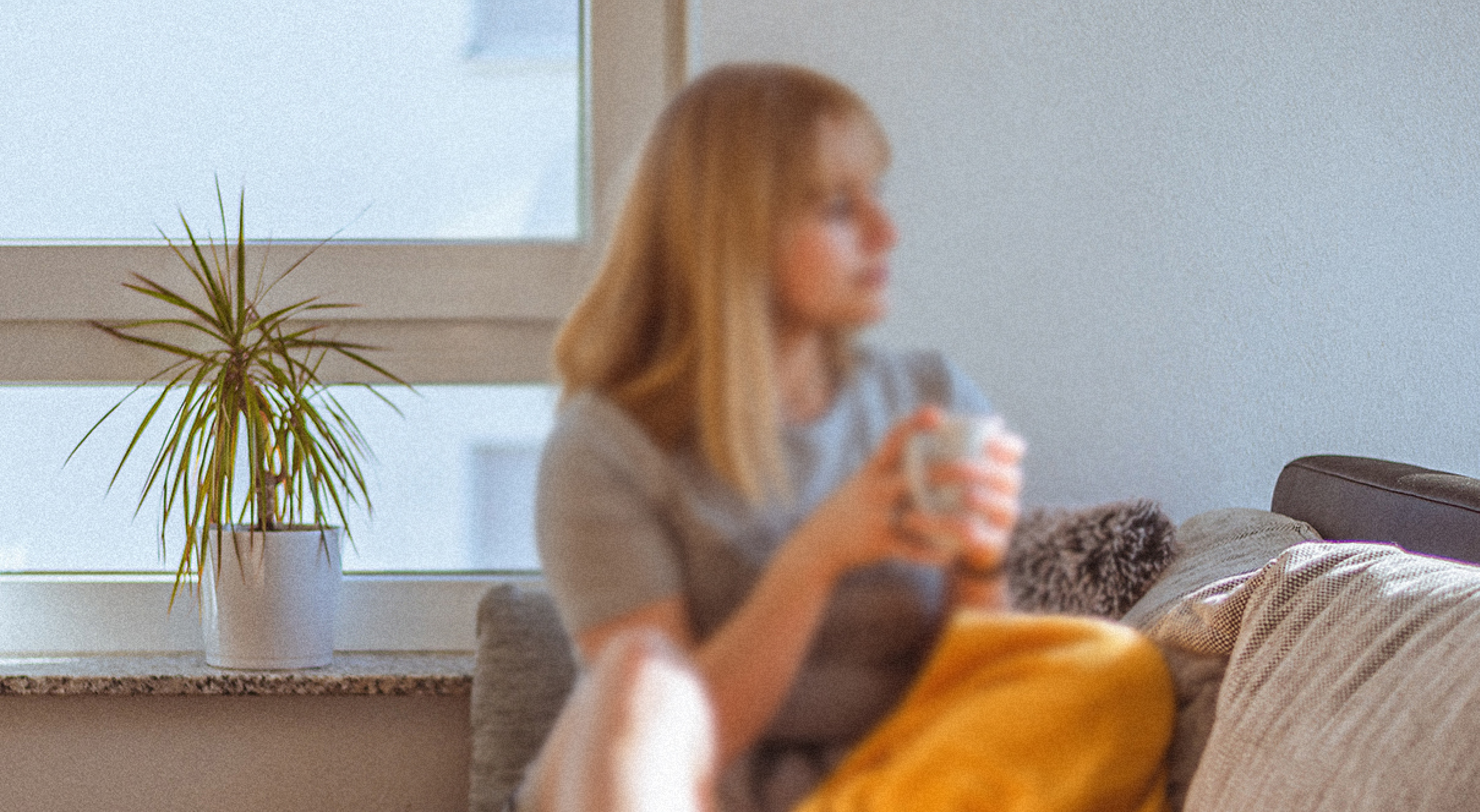 An image of a person holding a phone that is obscured by abstract scribbles