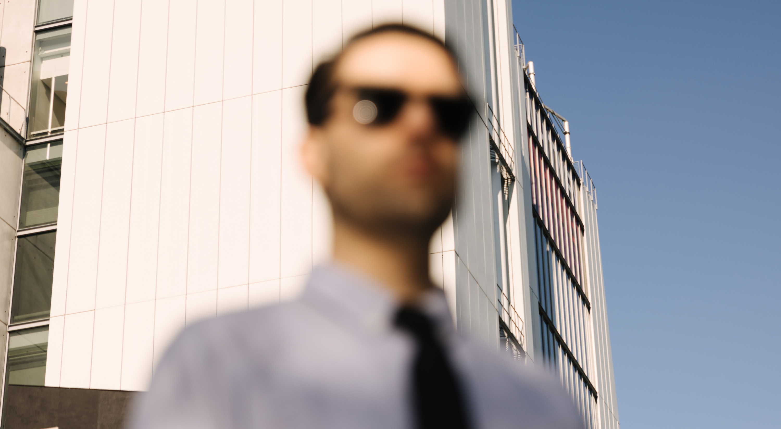 An image of a person standing in front of a building