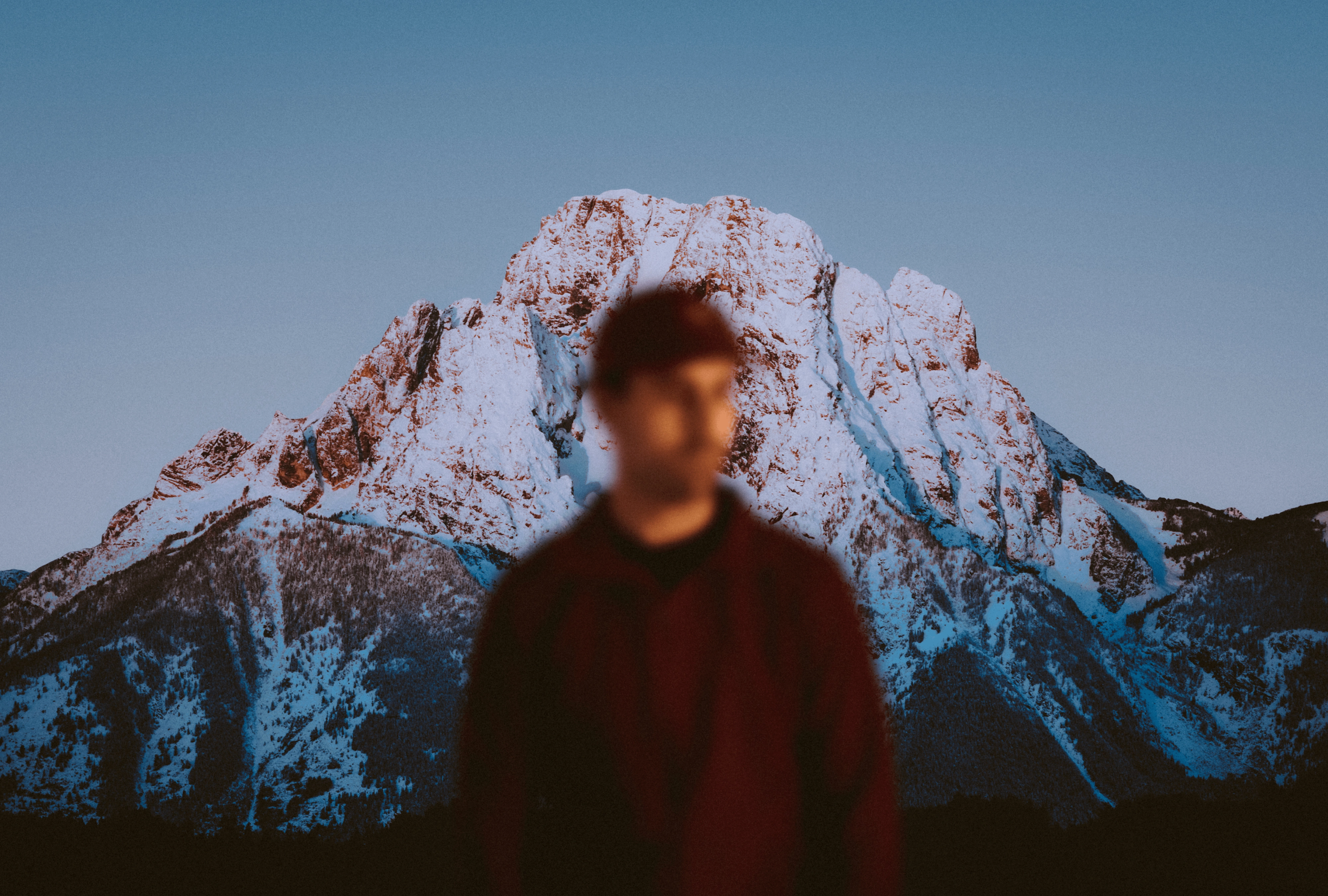 An image of a man in front of a mountain