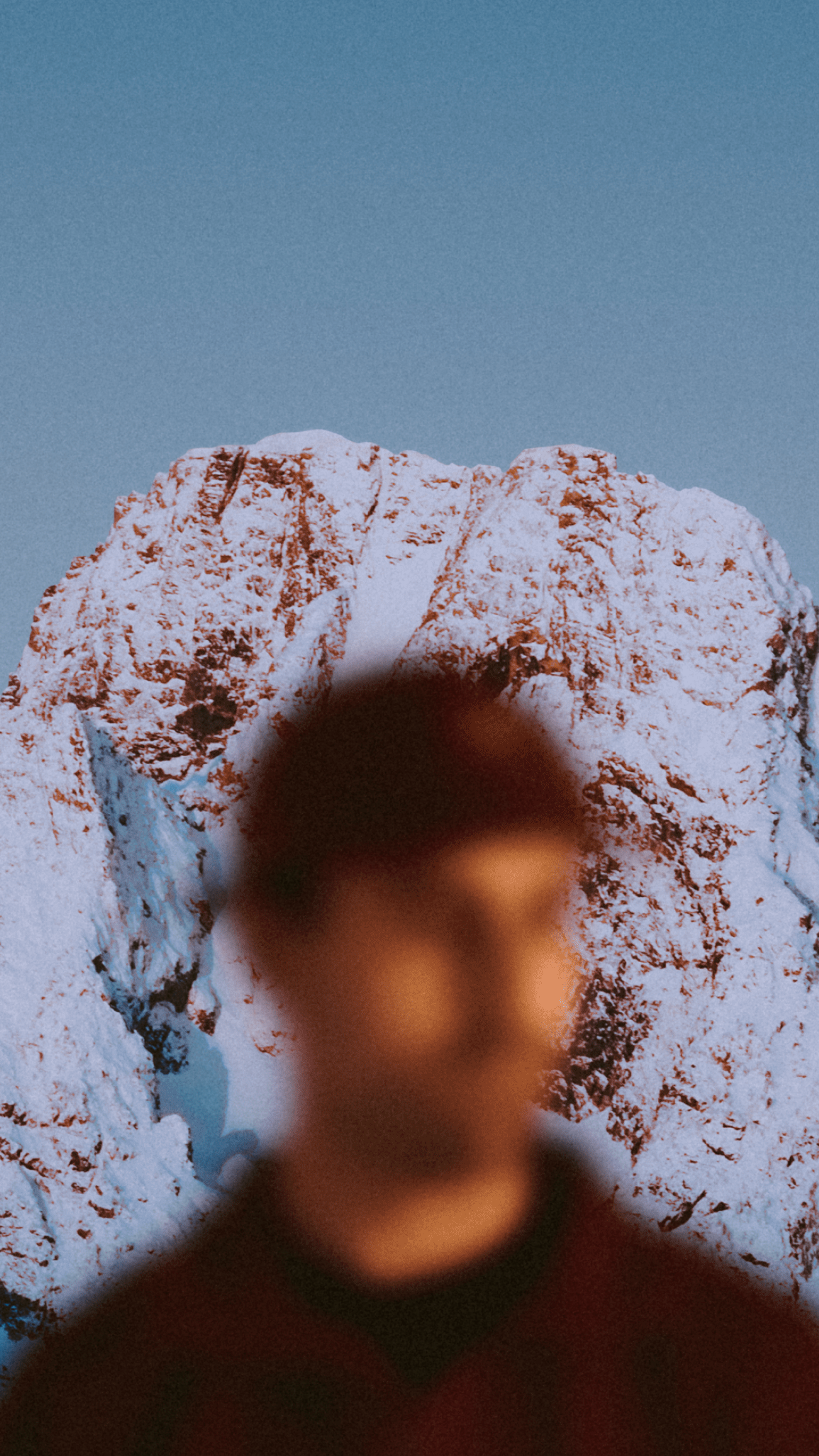 An image of a man in front of a mountain