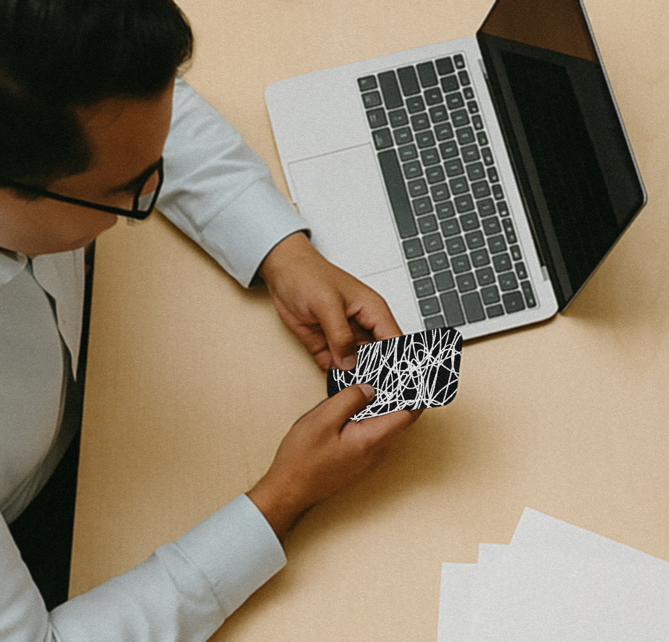 An image of two coworkers on their phones