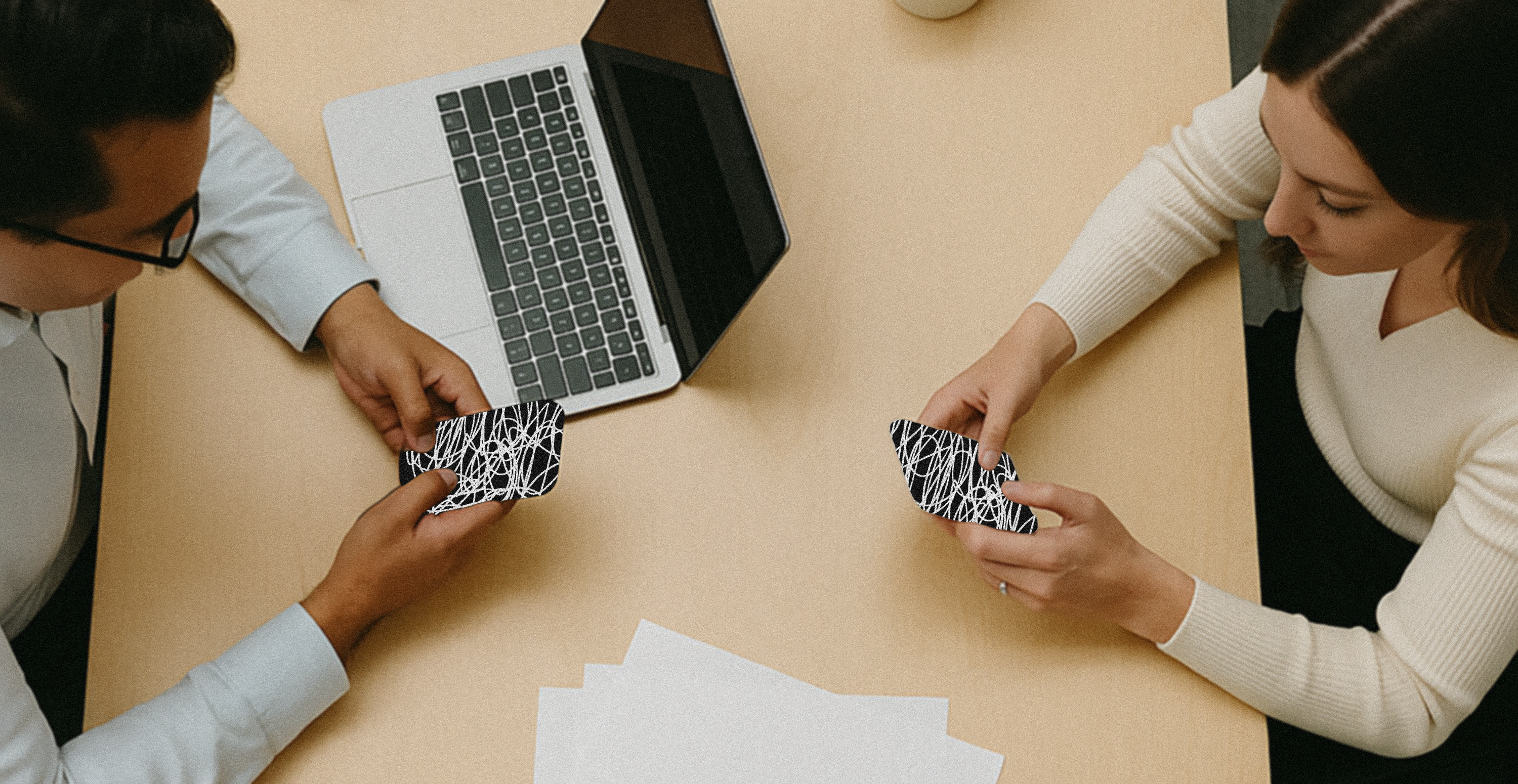 An image of two coworkers on their phones