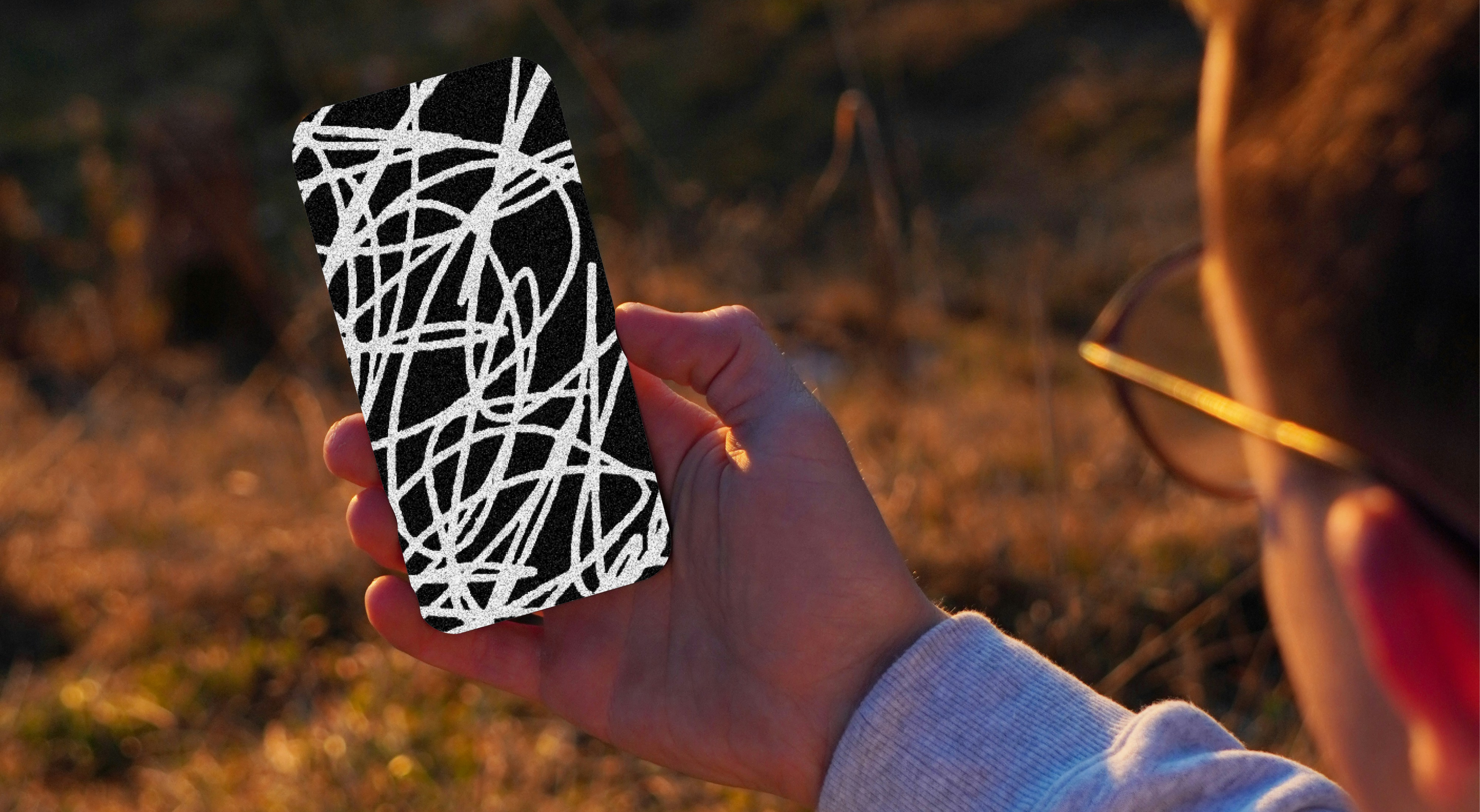 An image of a person holding a phone protected by Cape's privacy first network