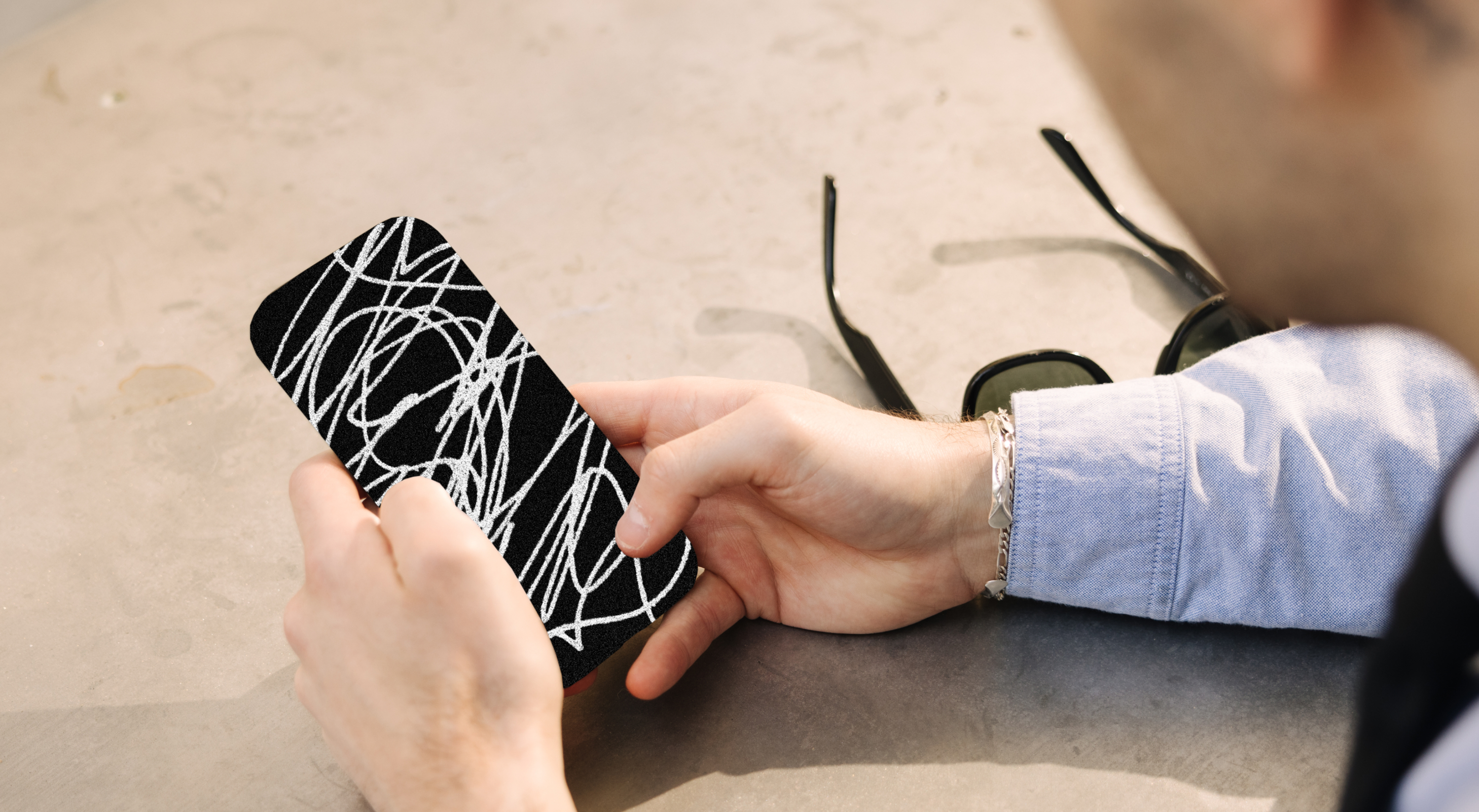 An image of a person holding a phone protected by Cape
