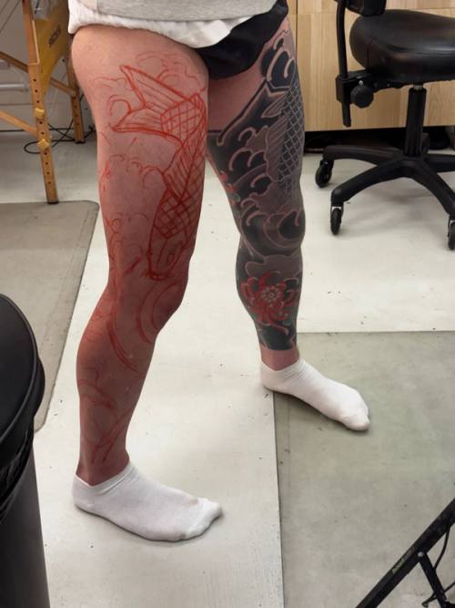 The red stencil on the left leg from the front, chrysanthemum low on the shin