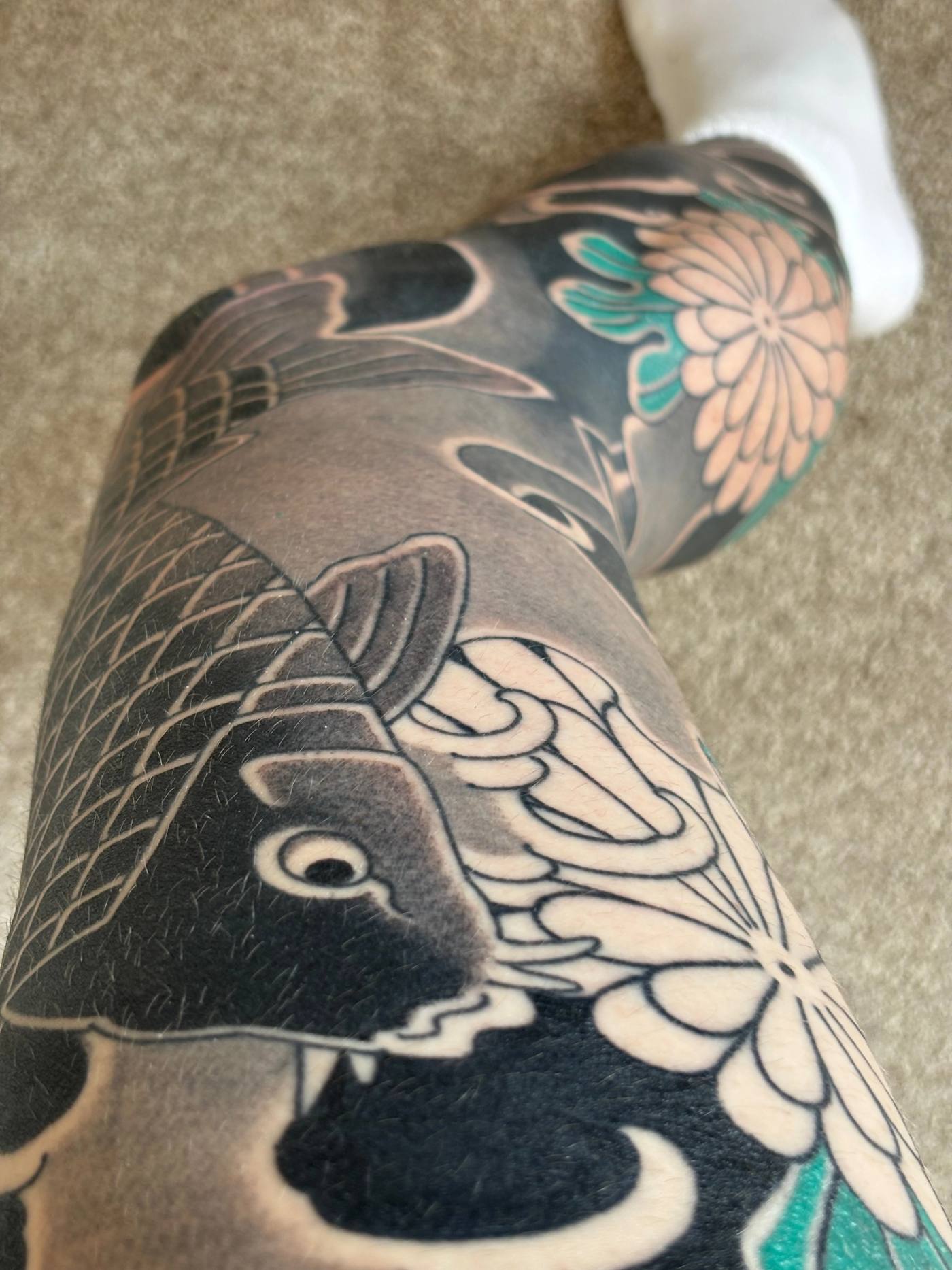The koi head on the thigh, close up and healed