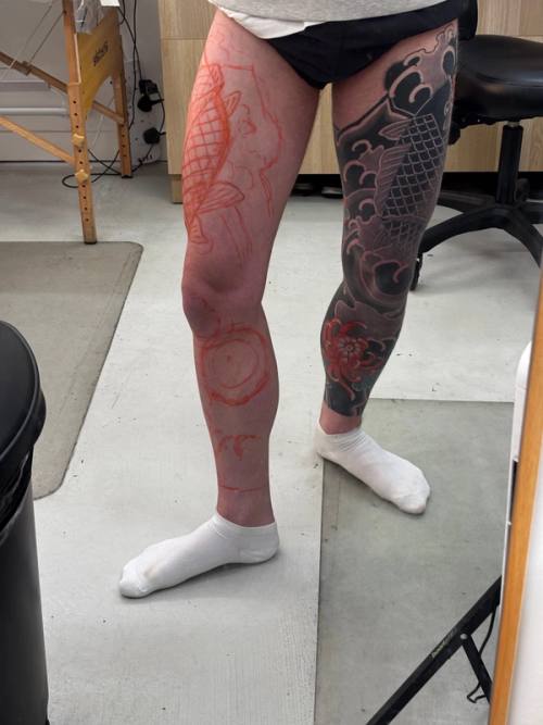 Front of the left leg with the koi and waves drawn on in red marker