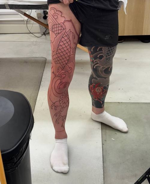 The koi outlined on the left thigh, the fresh lines and reddened skin
