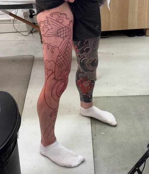 Upper left thigh after outlining, waves and koi scales freshly lined