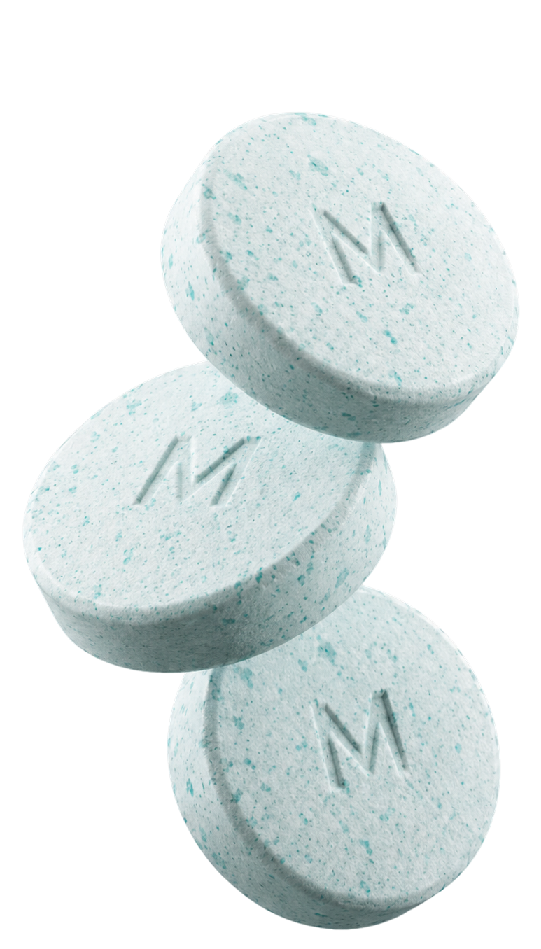 Three branded oral tablets stacked in a balanced arrangement on a transparent background