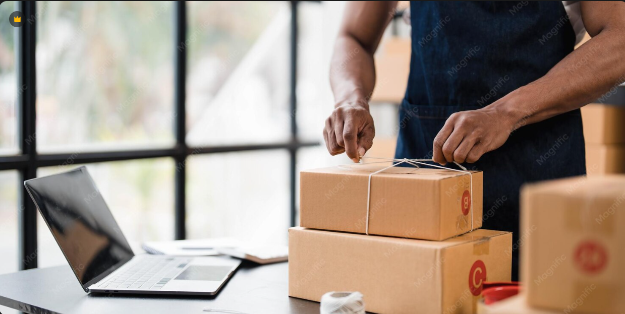 Worker packaging and preparing boxes for shipment in a fulfillment center