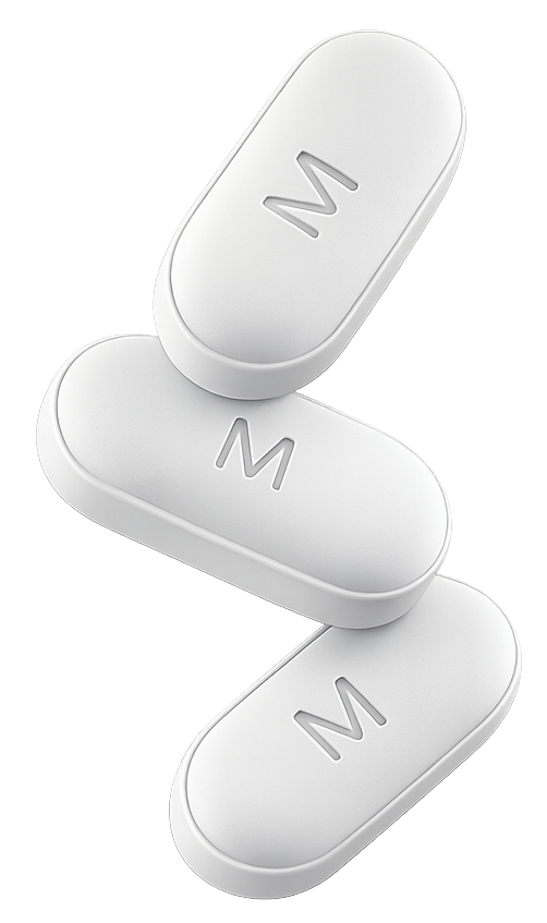 Three white oblong tablets with embossed M logo arranged in a balanced stack
