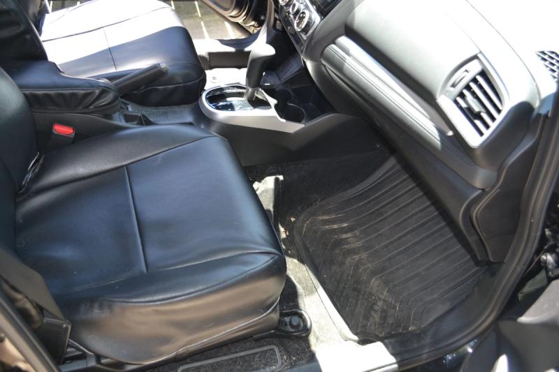 Black sedan exterior before paint correction with visible swirl marks and oxidation under direct sunlight