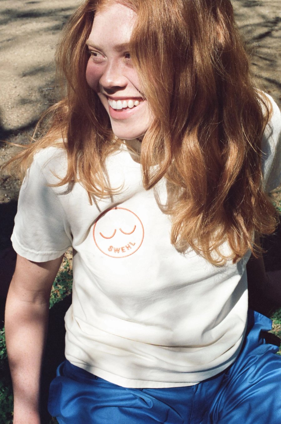 a white t - shirt laying on a tree trunk