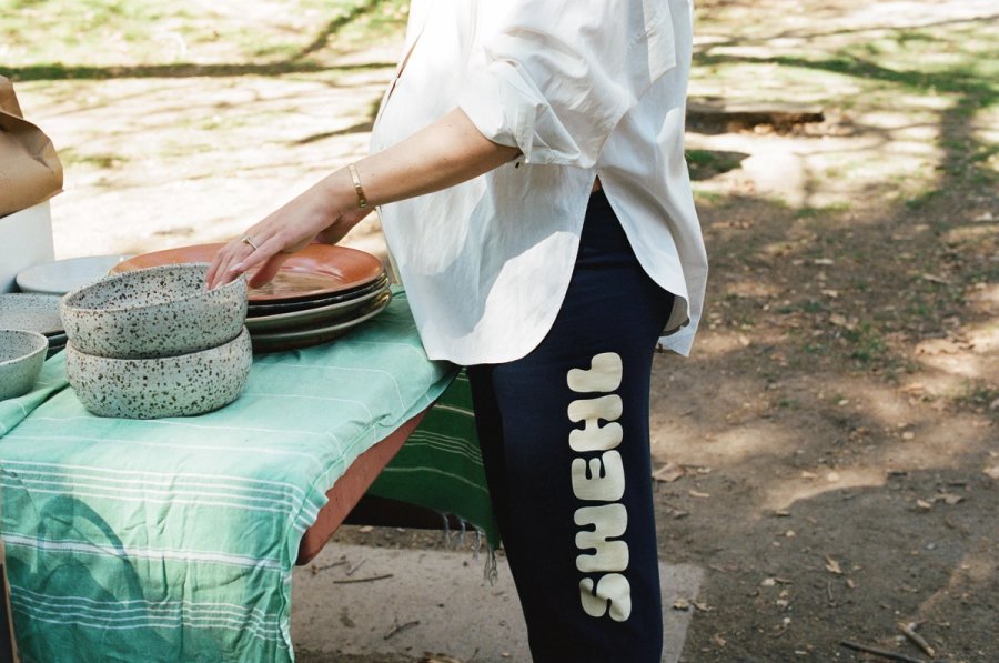a pair of blue pants laying on the ground next to a tree