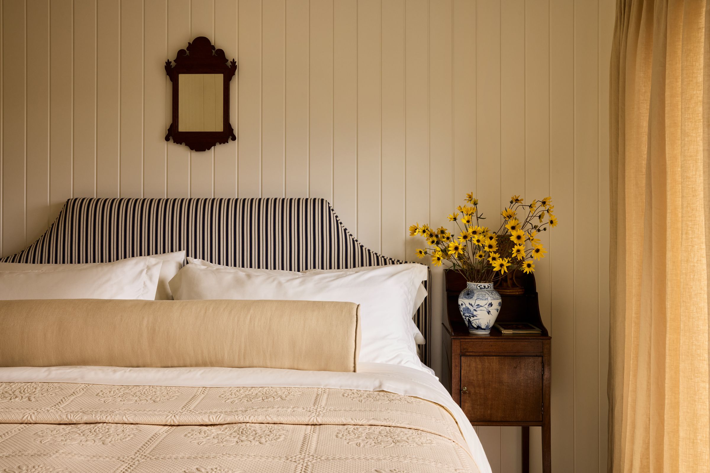Striped Upholstered bed with chippendale mirror above