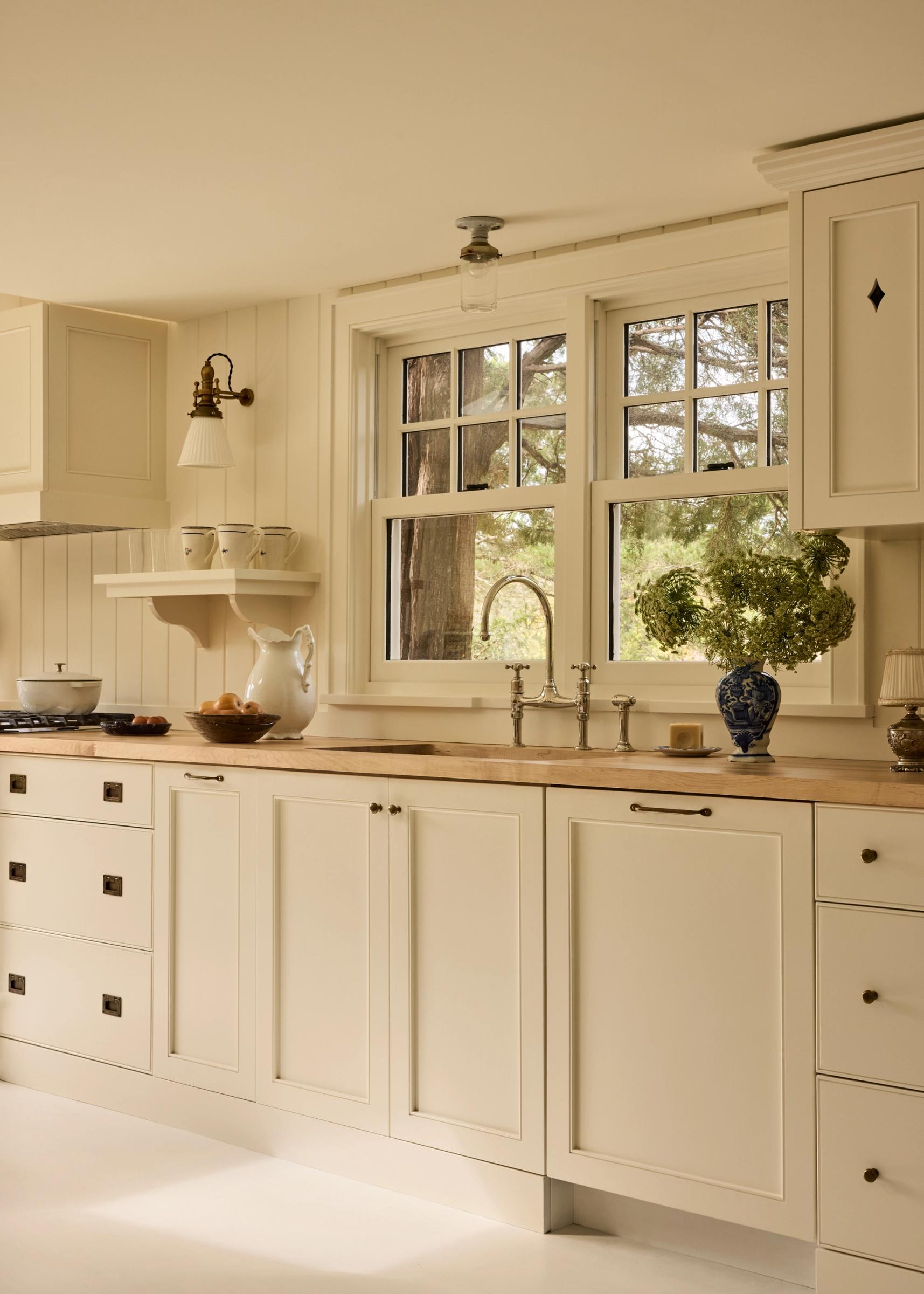 White painted cottage kitchen with butcher block counter top