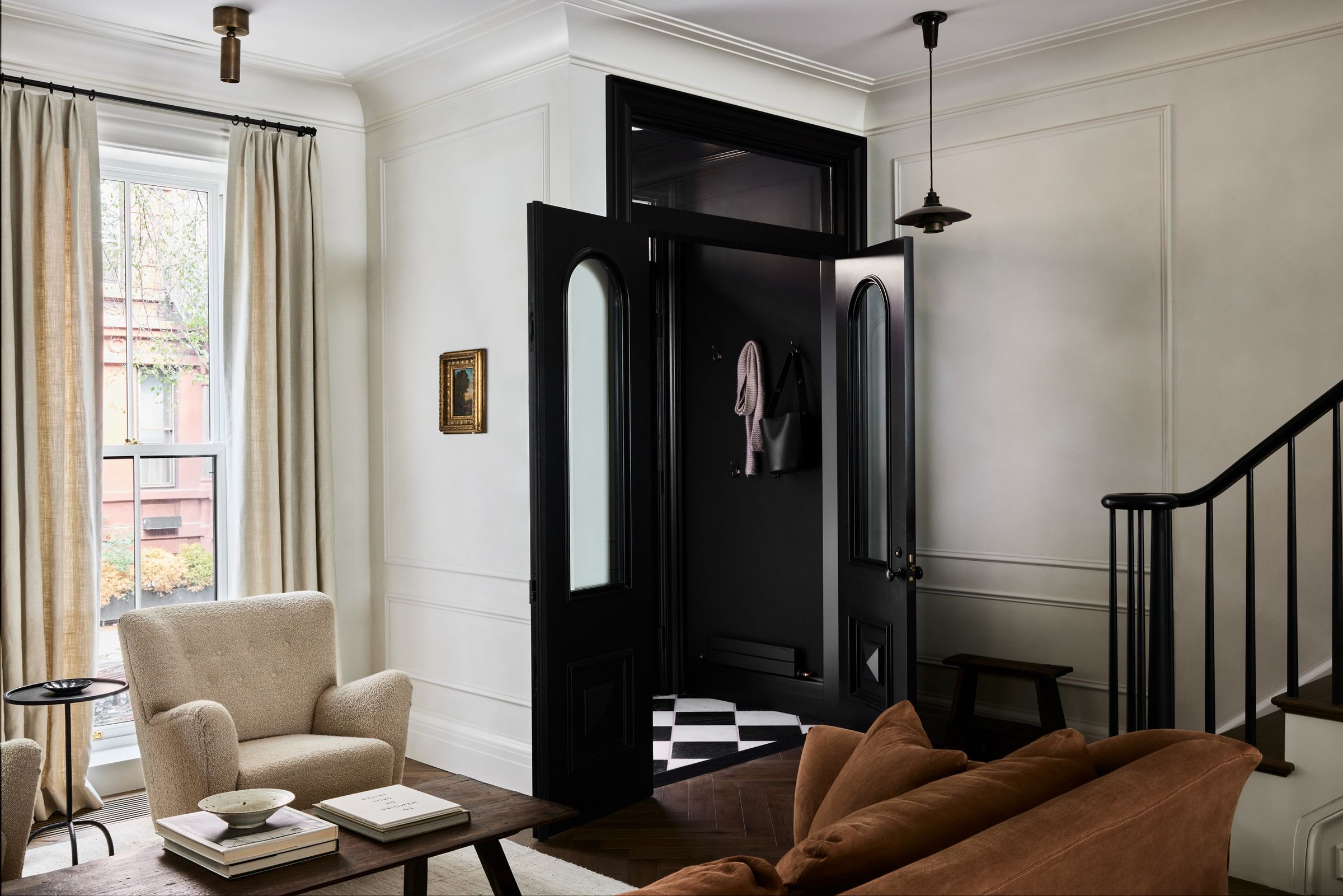 Brownstone entry hallway with black vestibule doors