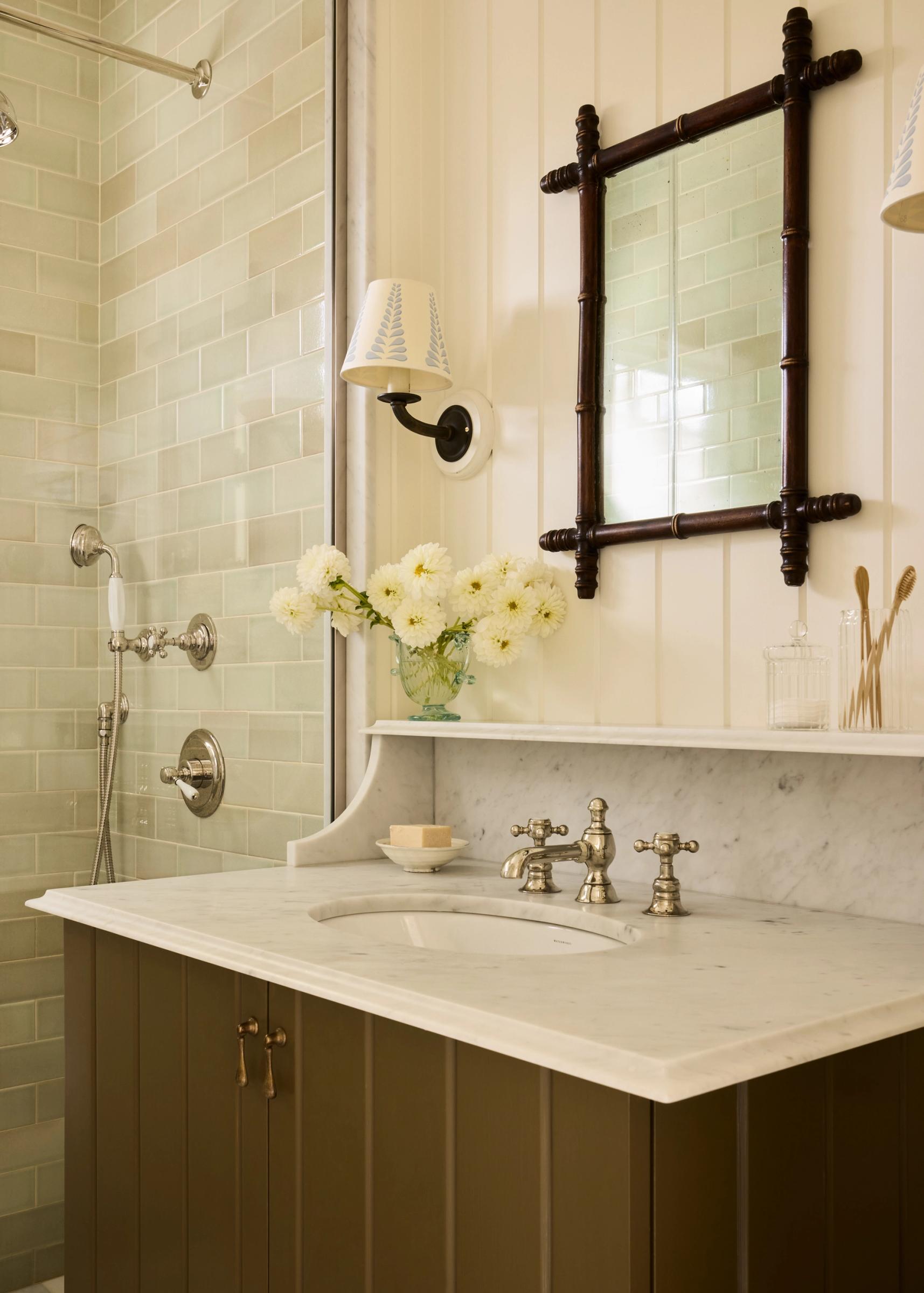 Bathroom with green vanity and marble counter top