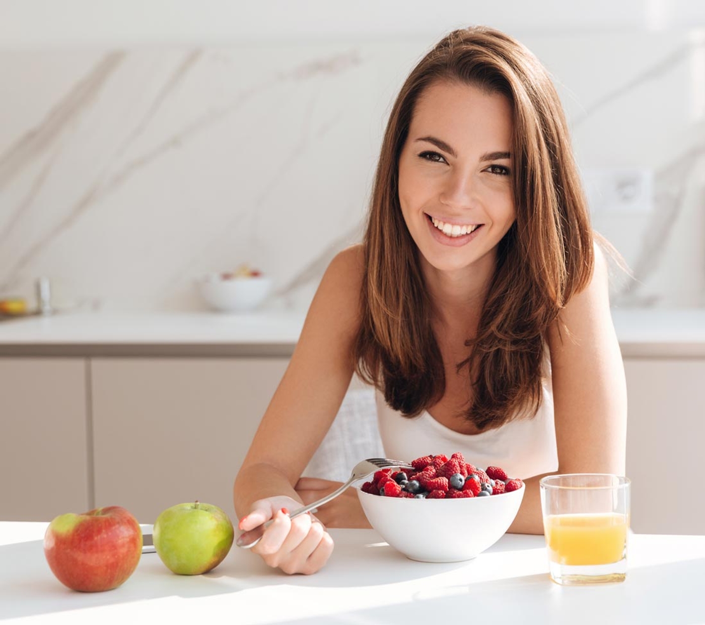 Woman eating a healthy breakfast smiling