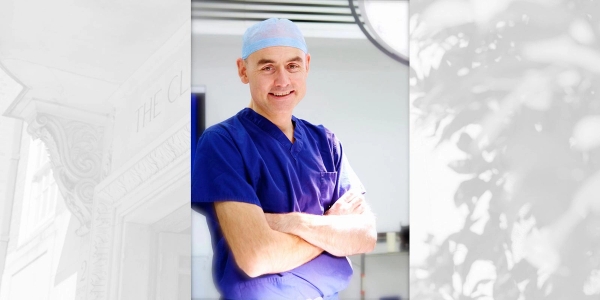 Mr Paul Harris in blue scrubs smiling