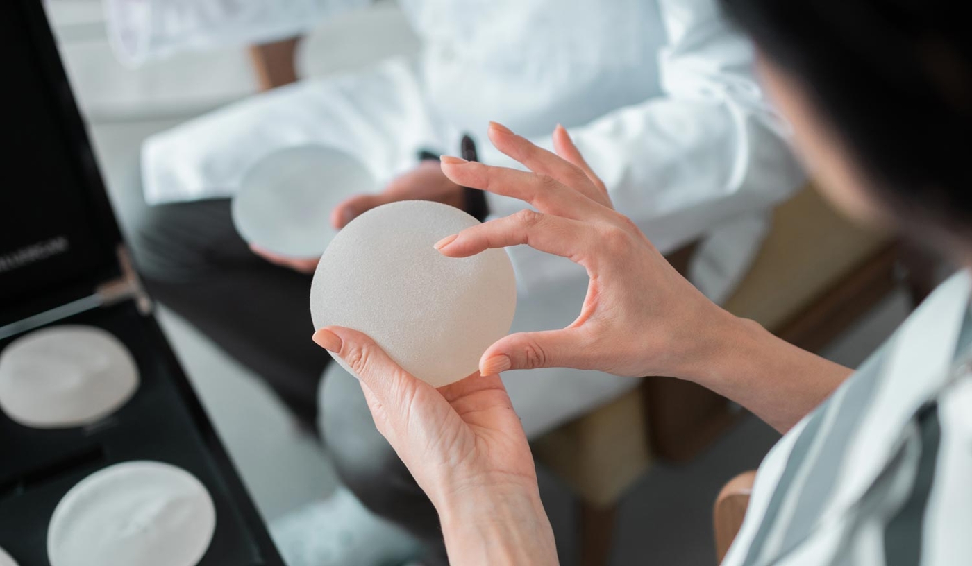 Close-up of hands handling a round implant
