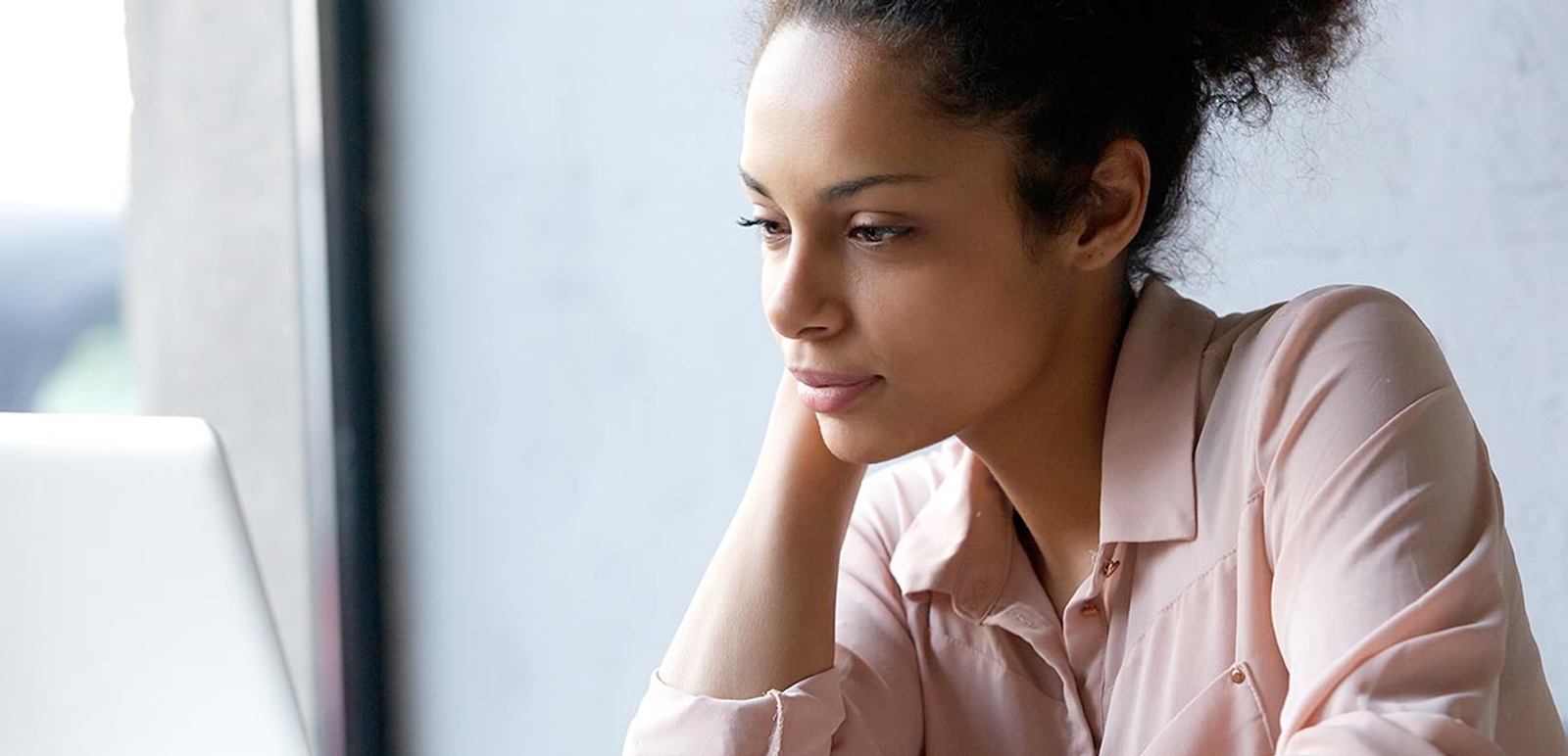 Woman looking intently into her laptop screen