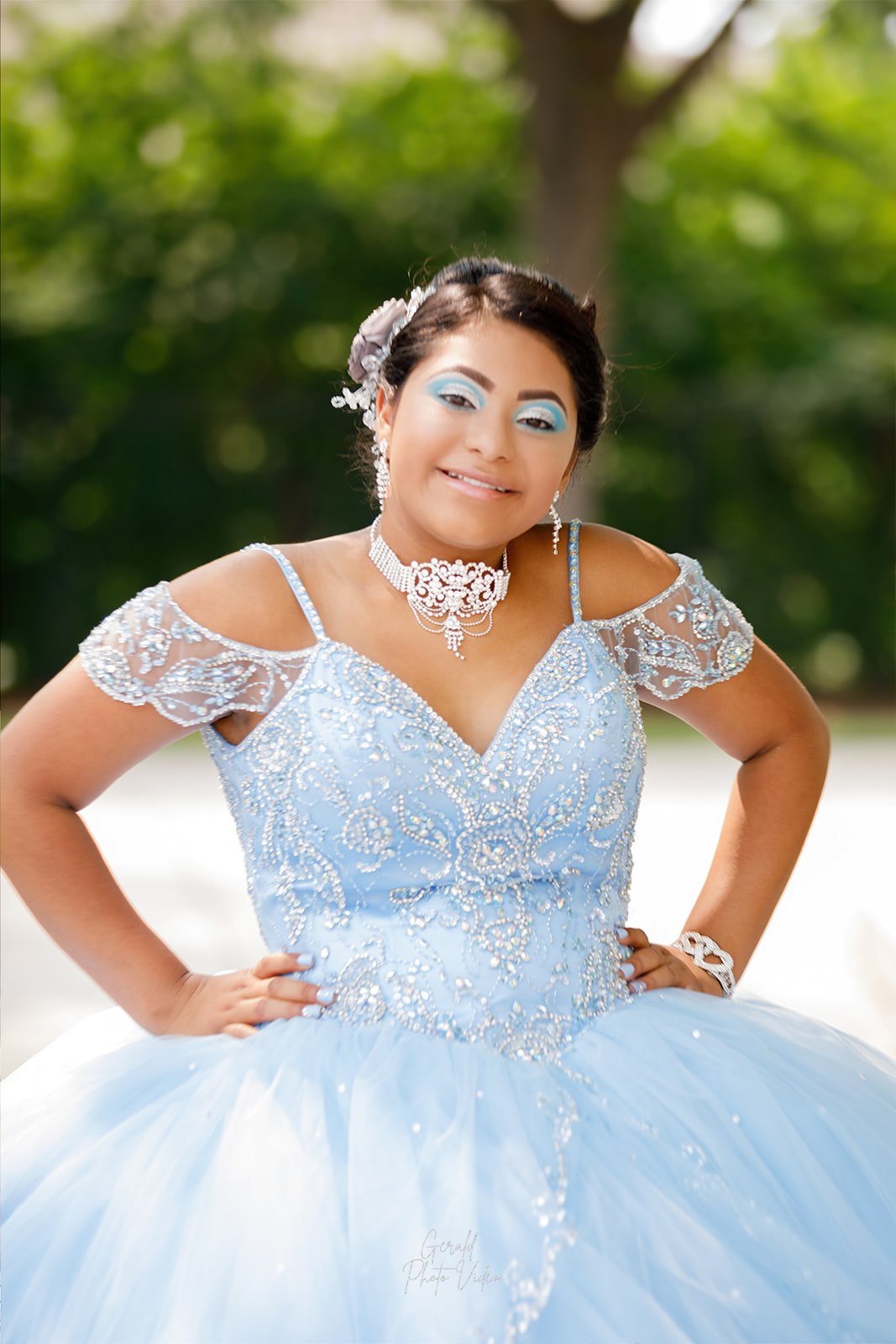Smiling quinceañera in a light blue gown with crystal details, Nebraska quinceañera photography