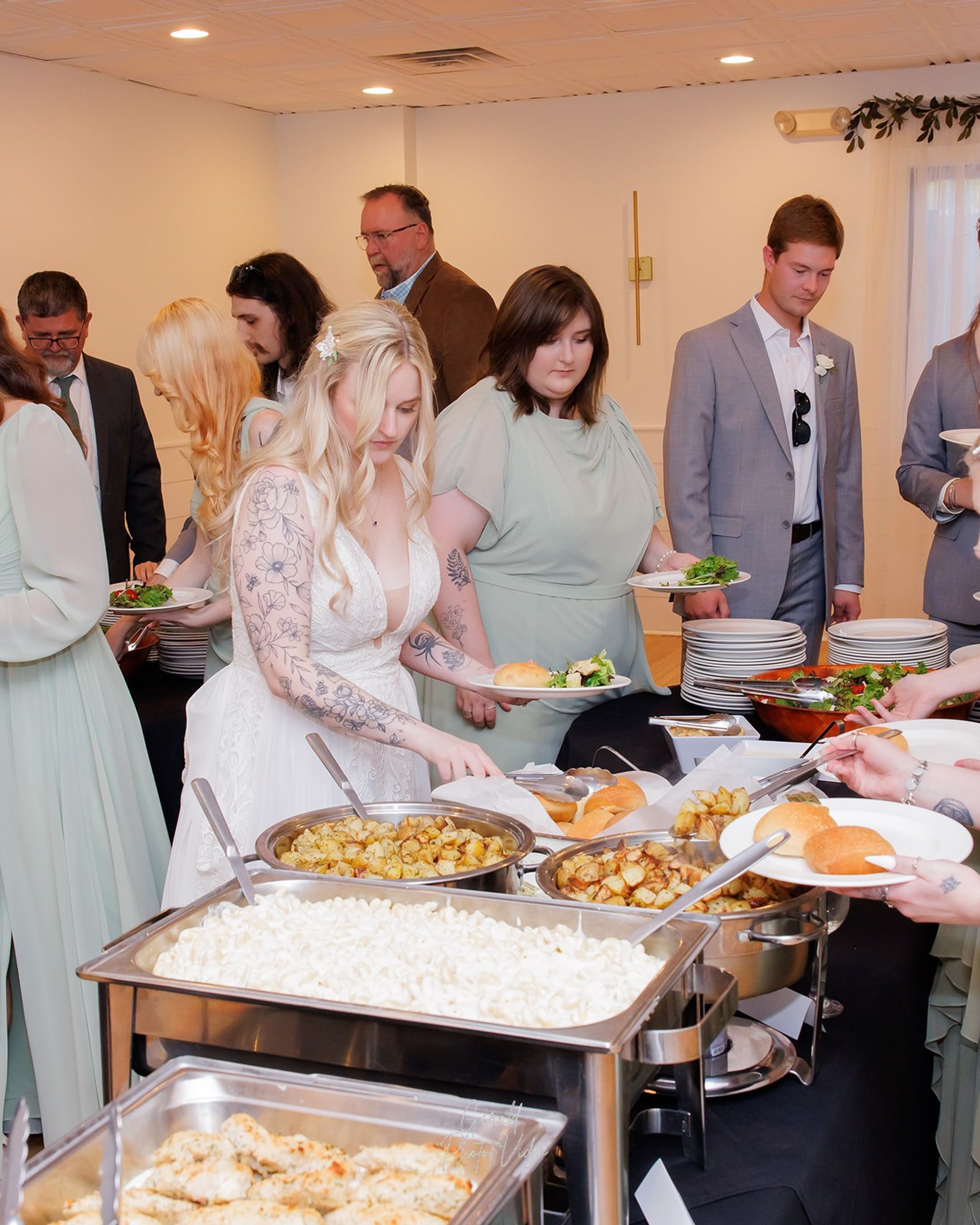 Bride and guests at the buffet line during the wedding reception in Omaha
