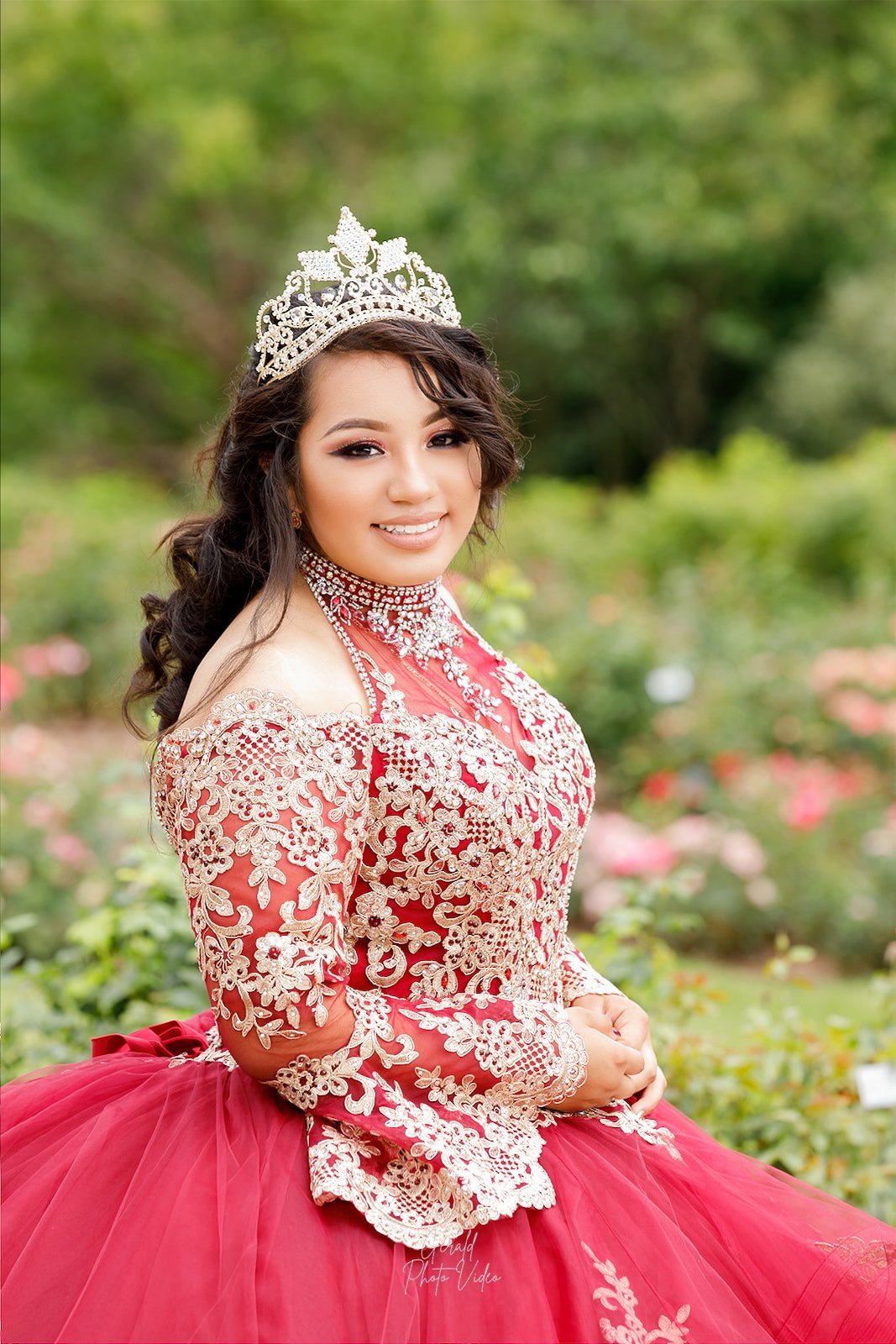 Quinceañera in a red and gold embroidered gown with tiara, photographed by Gerald Photo Video in Omaha