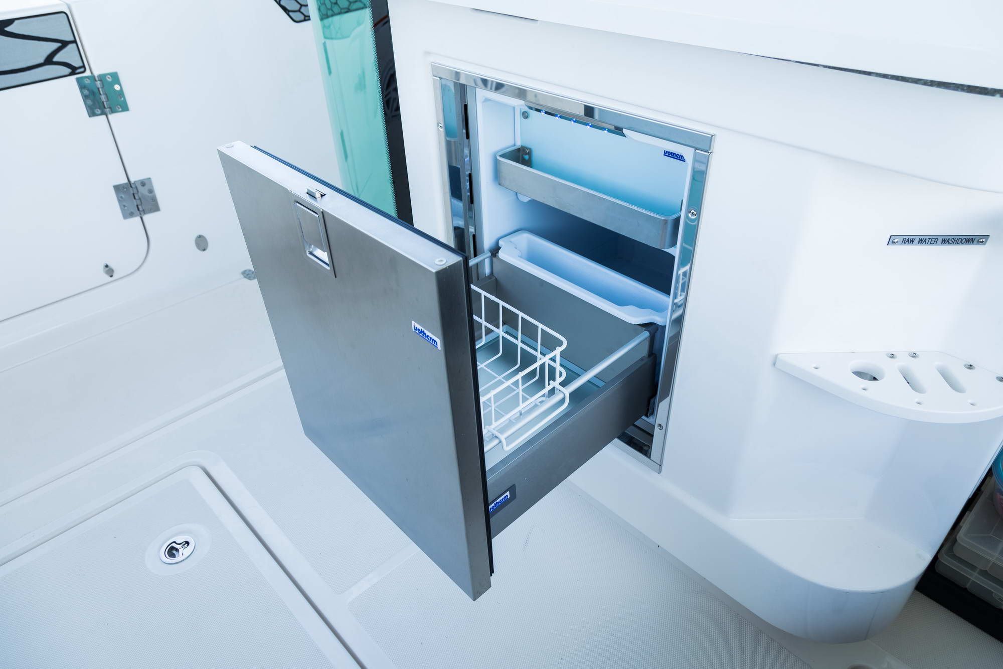 Open stainless steel drawer fridge on the deck of the Wellcraft Fisherman 352.