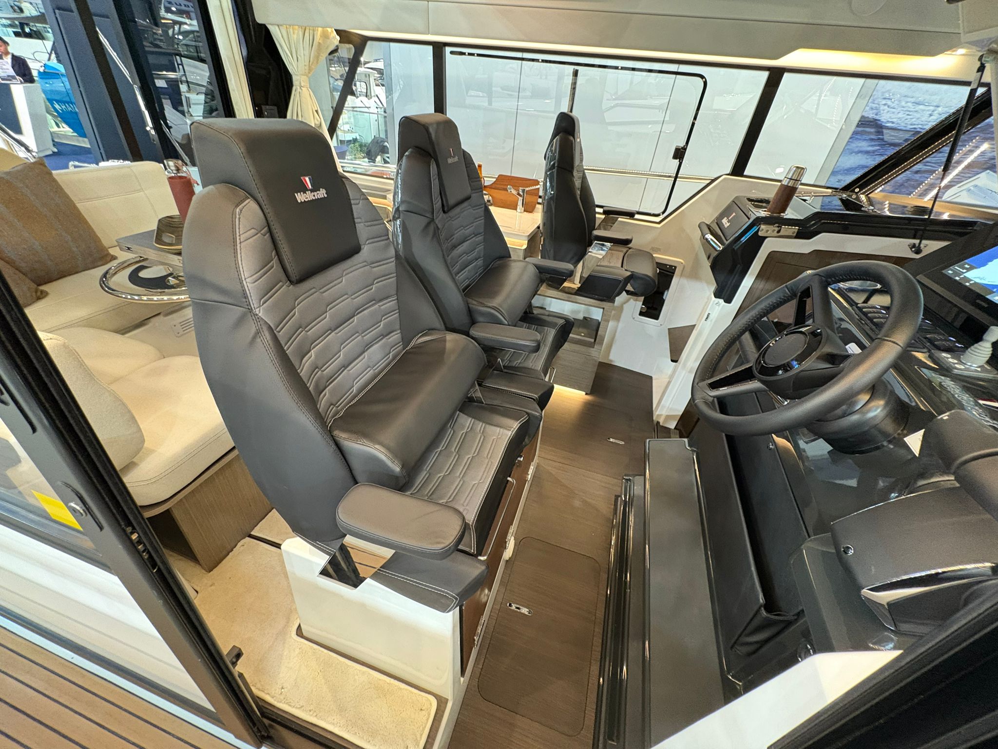 The interior of the Wellcraft 38 Explorer, showing the helm station with two seats and the control panel.