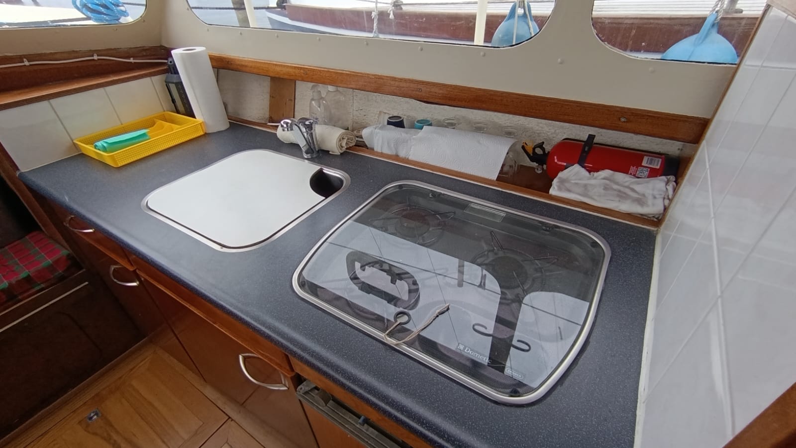 View of the galley with a gas stove and sink in the Aquanaut 750 cabin.