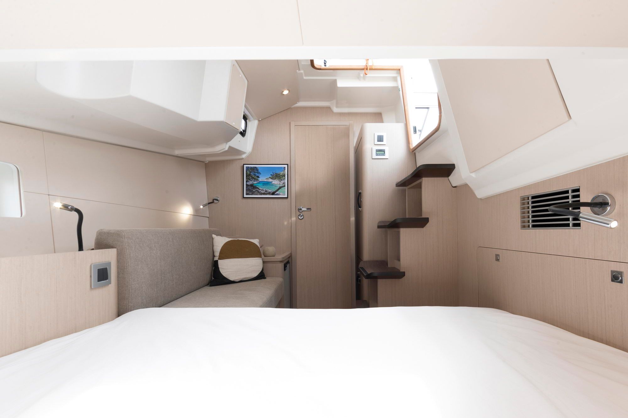 Interior of the owner's cabin on the Jeanneau Yachts 55 with a large bed and sofa.