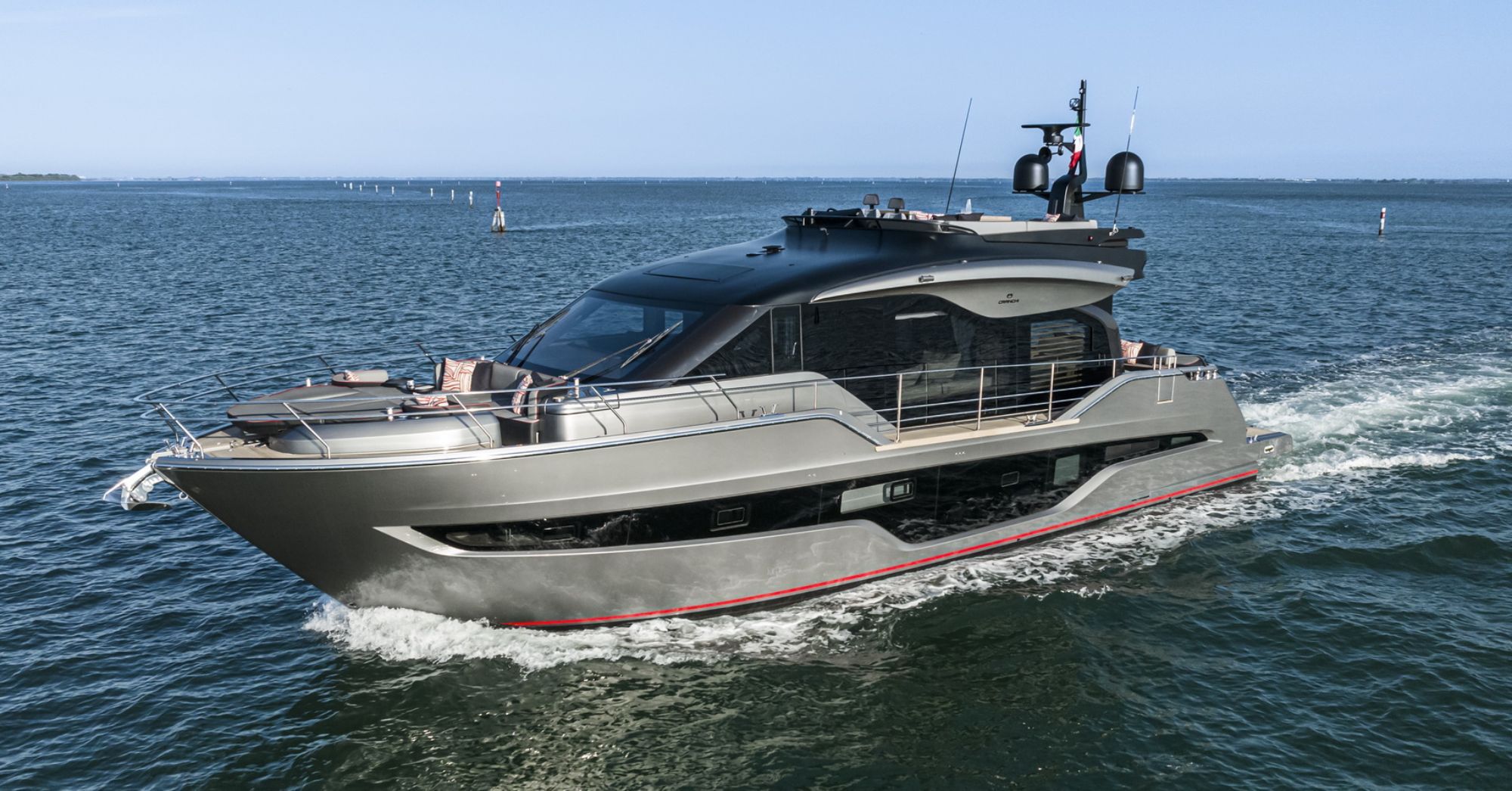The Cranchi Sessantasette 67 Corsa motor yacht underway on the open sea, side view.