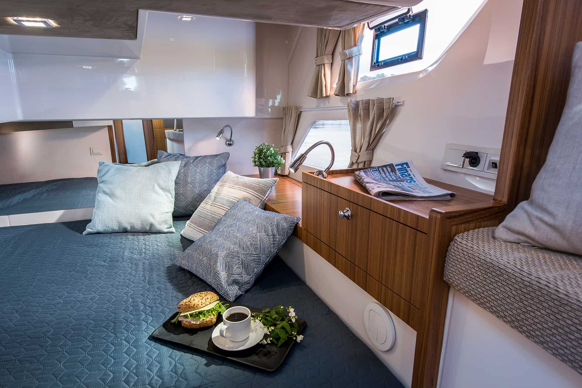 Interior of the bow cabin on the Marex 360 Cabriolet Cruiser motor yacht with bed and small table.