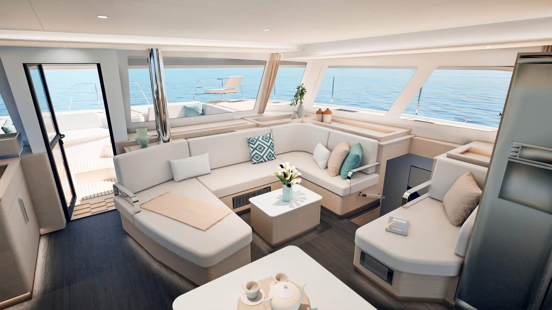 Spacious saloon of the Fountaine Pajot FP55 catamaran with large windows and a sea view, doors open to the forward deck.